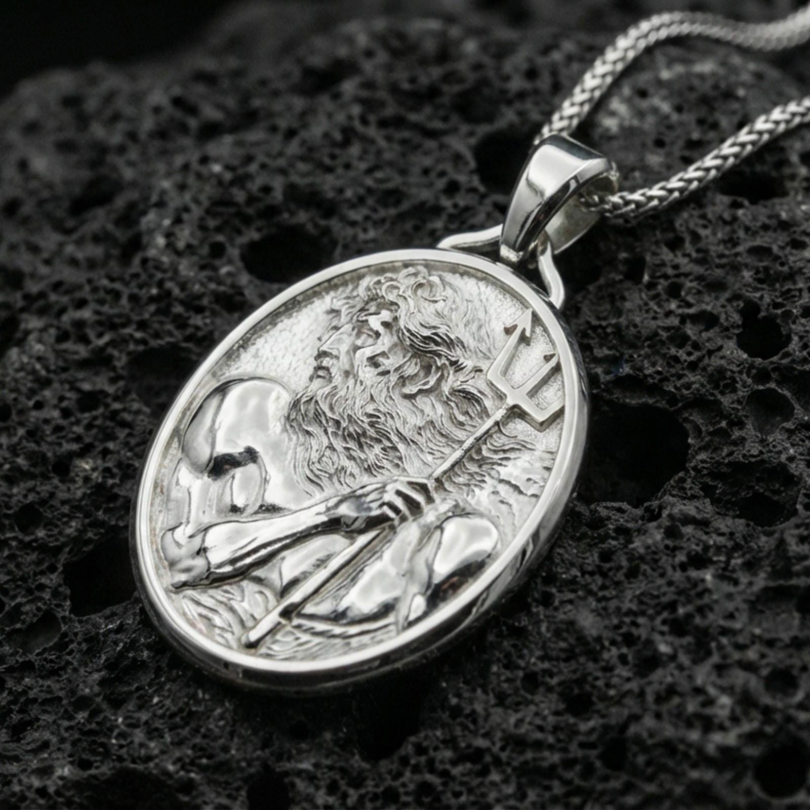 Polished silver Poseidon coin necklace on porous volcanic stone, Greek mythology trident medallion pendant