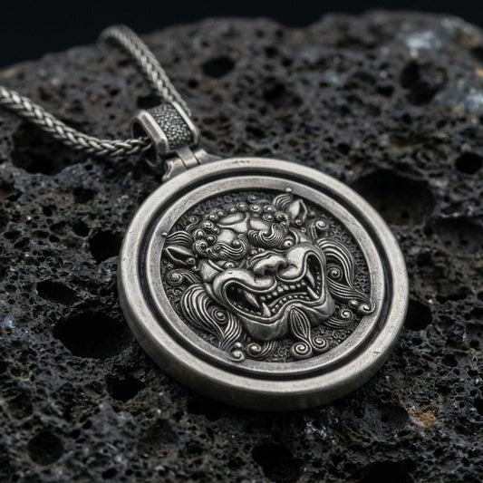Oxidized sterling silver guardian lion medallion pendant on volcanic rock, rotating disk design, macro product shot