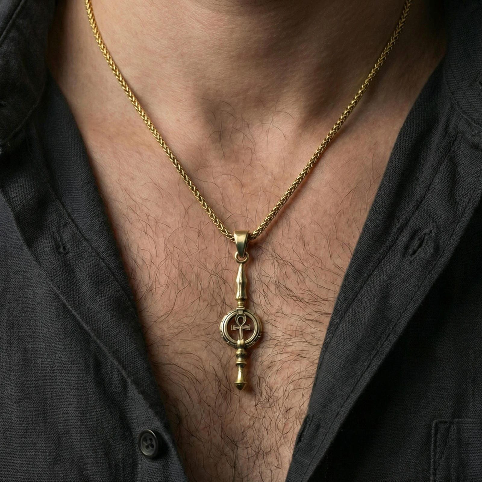 Gold plated ankh spear pendant necklace worn on neck, premium styling, symbolic ankh spear as focal point
