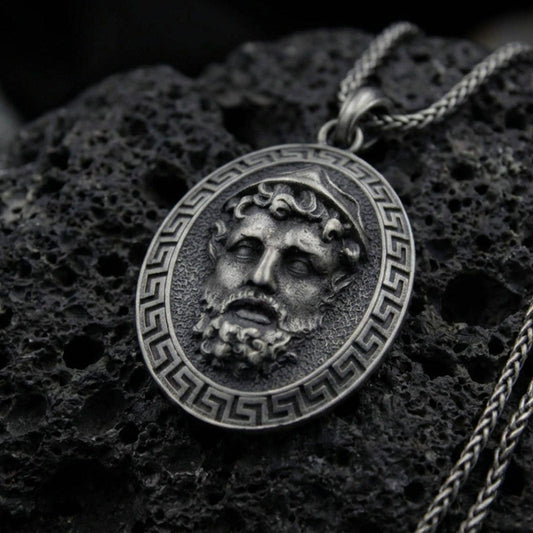 Oxidized sterling silver Medusa face pendant on volcanic rock, Greek key border medallion, macro studio shot