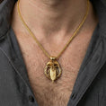 Load image into Gallery viewer, Gold plated Odin spear raven pendant necklace worn on neck, premium styling, Norse amulet as focal point
