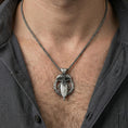 Load image into Gallery viewer, Oxidized Odin’s spear and raven pendant necklace worn on neck, lifestyle close-up, braided chain and pendant centered
