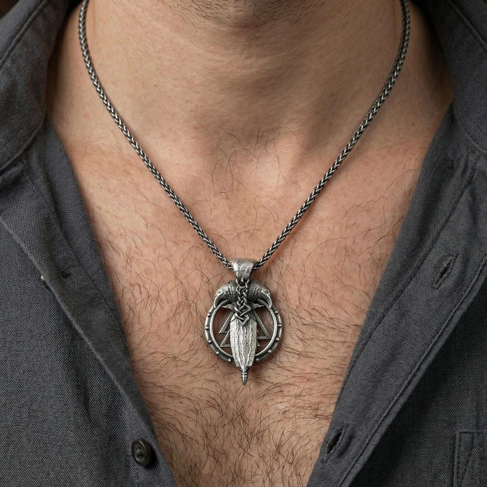 Oxidized Odin’s spear and raven pendant necklace worn on neck, lifestyle close-up, braided chain and pendant centered