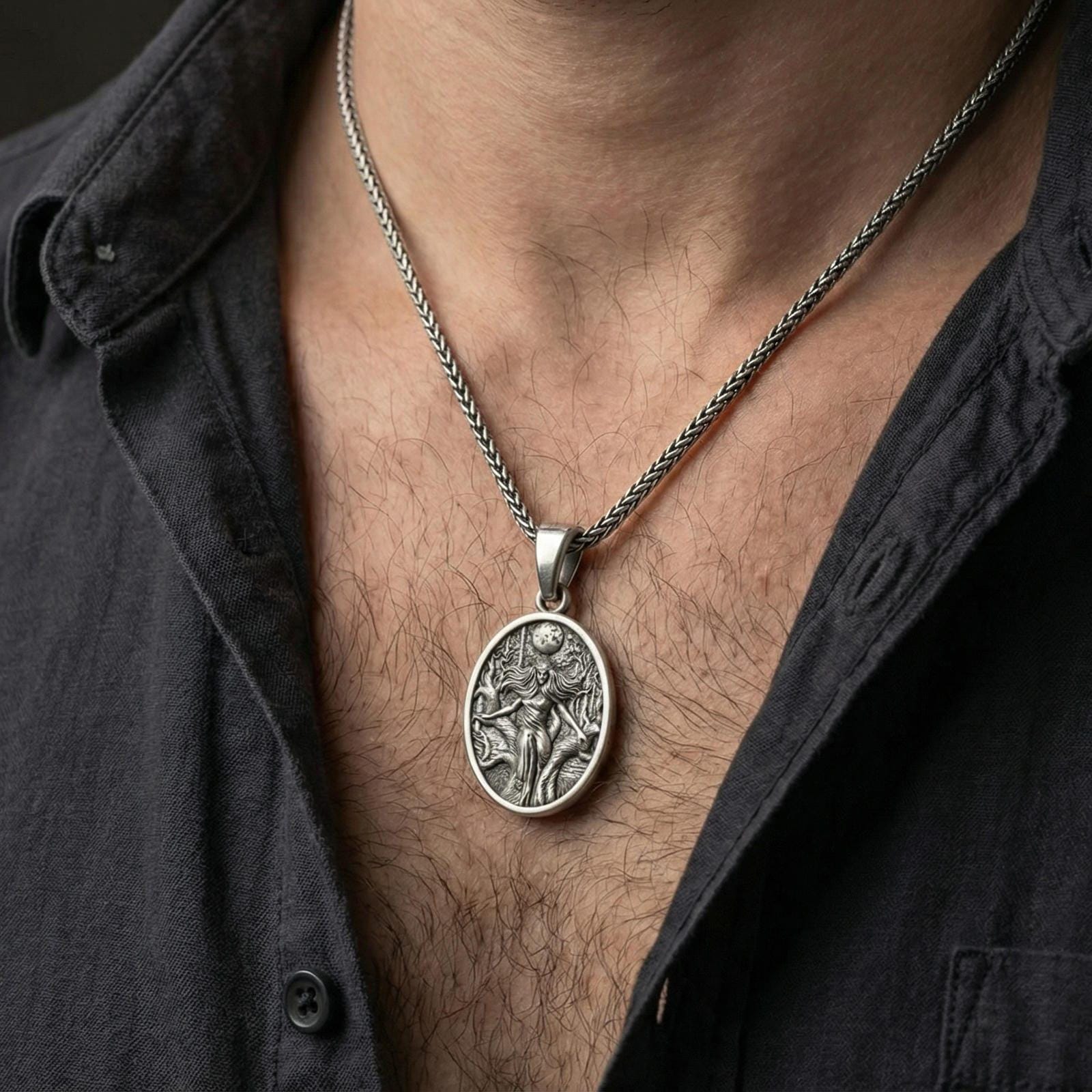 Oxidized Hela pendant necklace worn on neck, lifestyle close-up, oval medallion centered with braided chain