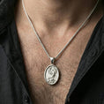 Load image into Gallery viewer, Polished silver phoenix medallion necklace worn on neck, clean lifestyle framing, reflective finish and sharp relief
