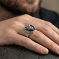 Load image into Gallery viewer, Oxidized bull head signet ring worn on finger, lifestyle close-up, octagonal face centered with rugged masculine styling
