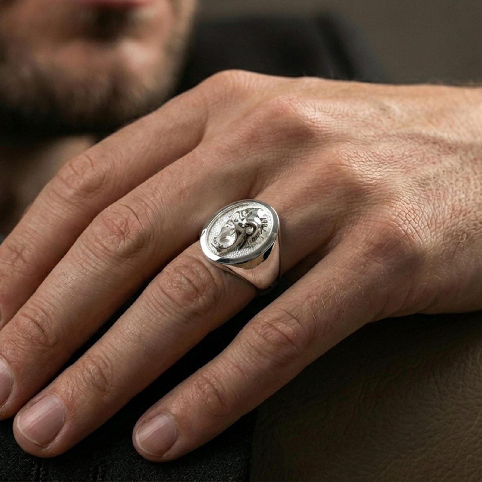 Polished silver gorilla head signet ring worn on finger, clean lifestyle framing, reflective finish and sharp relief definition
