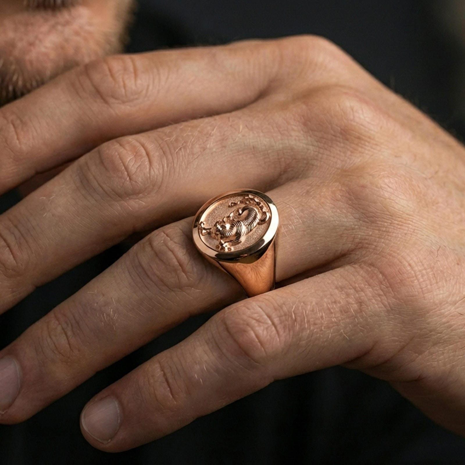 Rose gold plated tiger signet ring worn on finger, lifestyle wear shot, warm plating tone and sculpted depth