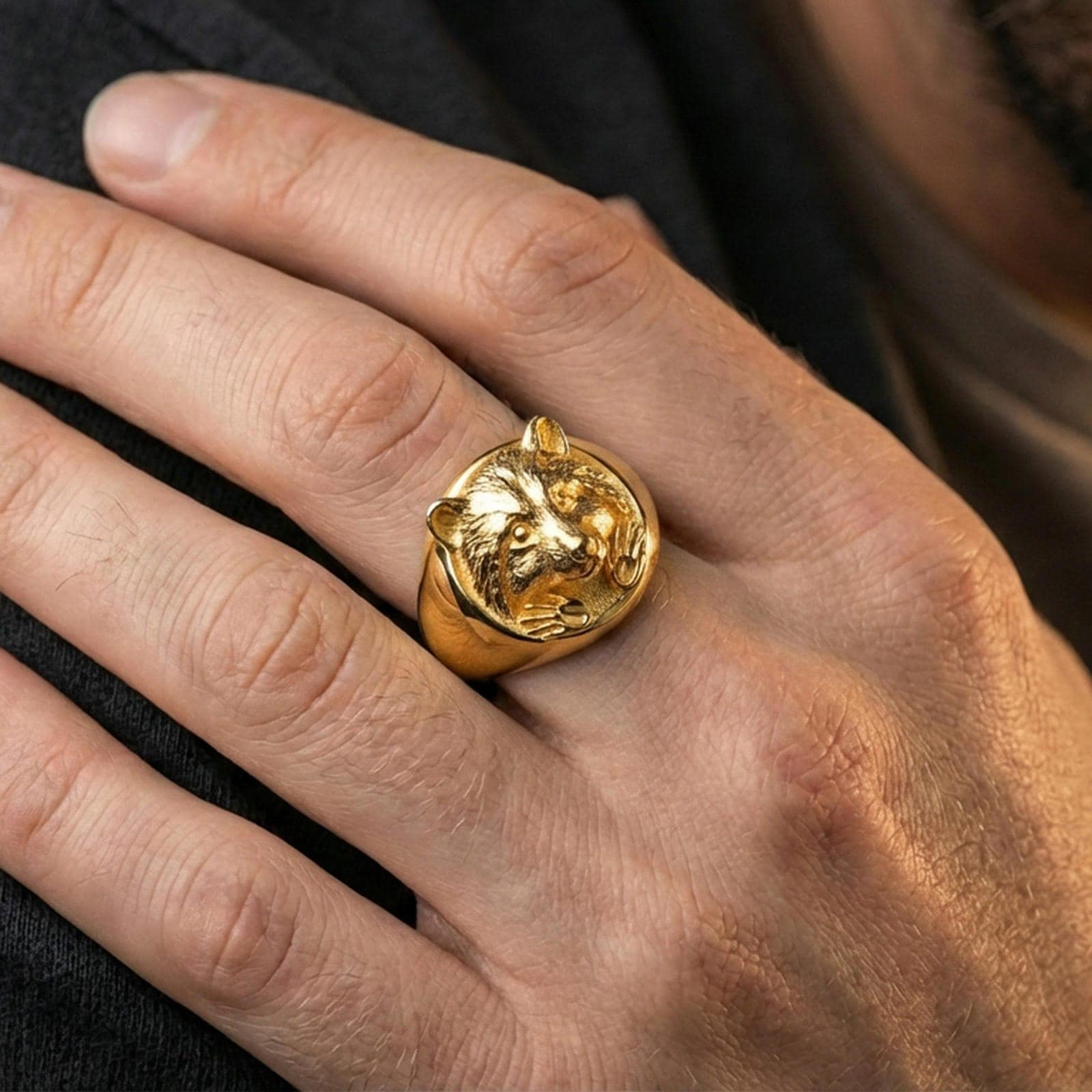 Gold plated raccoon head signet ring worn on finger, premium styling, statement animal ring as focal point on hand