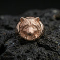 Load image into Gallery viewer, Rose gold plated raccoon signet ring on volcanic rock, textured lava stone background, detailed face and paw engraving
