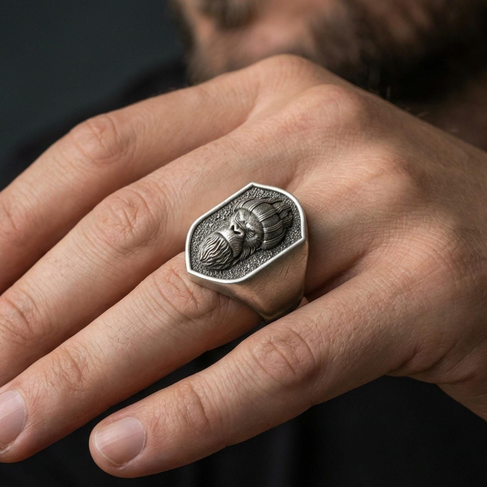 Oxidized gorilla warrior signet ring worn on finger, lifestyle close-up, shield face centered with rugged masculine styling