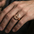 Load image into Gallery viewer, Rose gold plated octopus signet ring worn on finger, lifestyle wear shot, octopus symbol ring emphasizing tentacle relief and round face

