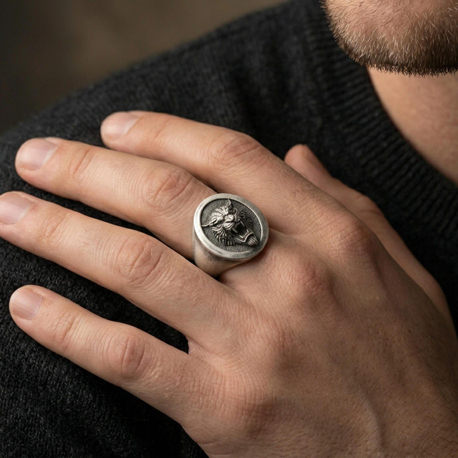 Oxidized tiger oval signet ring worn on finger, lifestyle close-up, roaring tiger head relief centered on oval face