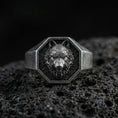 Load image into Gallery viewer, Oxidized sterling silver wolf signet ring on volcanic rock, octagonal face with raised wolf head relief and dark textured background, macro product photo
