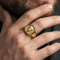 Load image into Gallery viewer, Gold plated wolf octagon signet ring worn on finger, premium lifestyle photo, statement wolf totem ring with detailed fur carving
