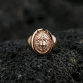 Load image into Gallery viewer, Rose gold plated wolf signet ring on volcanic rock, oval wolf crest signet with defined muzzle and layered fur carving, luxury product photo
