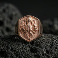 Load image into Gallery viewer, Rose gold plated octopus signet ring on volcanic rock, shield octopus crest signet with sculpted tentacles and hammered-look recessed surface, luxury product photo
