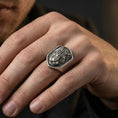 Load image into Gallery viewer, Oxidized shield tiger signet ring worn on finger, lifestyle close-up showing raised tiger head emblem and wide tapered band profile
