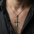 Load image into Gallery viewer, Oxidized sword pendant necklace worn on neck, lifestyle close-up on dark outfit, minimal premium studio look
