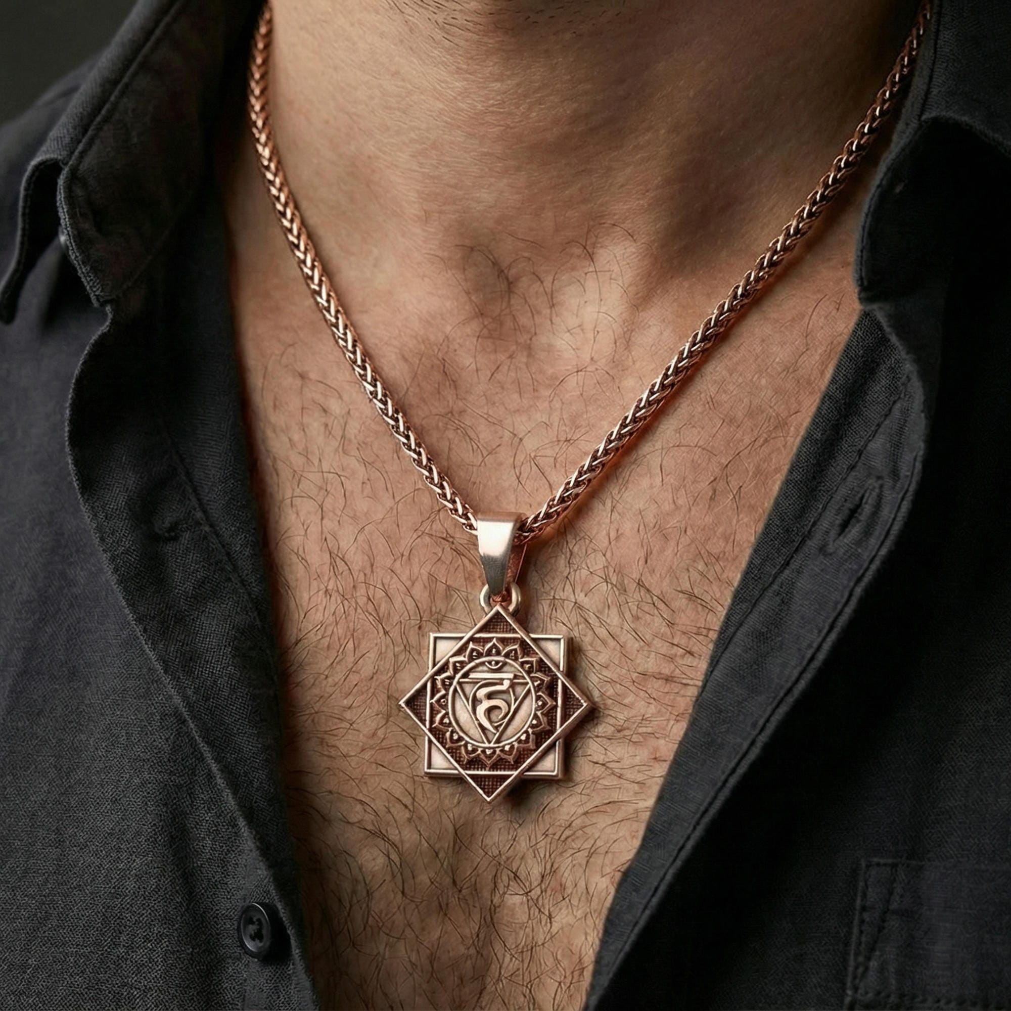 Rose gold plated Vishuddha pendant necklace worn on neck, lifestyle composition with dark clothing, crisp chakra silhouette