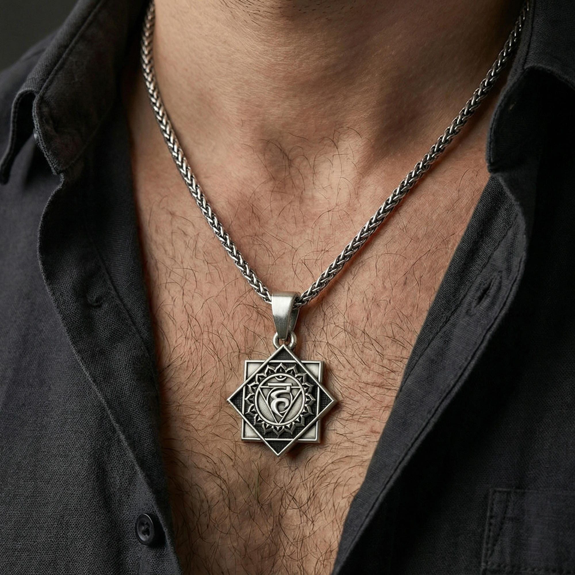 Oxidized Throat Chakra pendant necklace worn on neck, lifestyle close-up on dark outfit, Vishuddha symbol centered