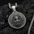 Load image into Gallery viewer, Oxidized Zeus pendant on textured volcanic rock, macro close-up, Greek mythology medallion with lightning detail, premium studio lighting
