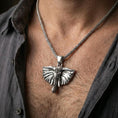 Load image into Gallery viewer, Polished silver elephant pendant on chain worn on neck, natural lifestyle framing, ears and tusks clearly visible
