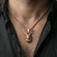 Load image into Gallery viewer, Rose gold plated rabbit pendant necklace worn on neck, lifestyle composition with dark clothing, crisp rabbit silhouette
