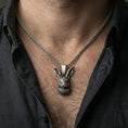 Load image into Gallery viewer, Oxidized rabbit head pendant necklace worn on neck, lifestyle close-up on dark outfit, hare charm centered

