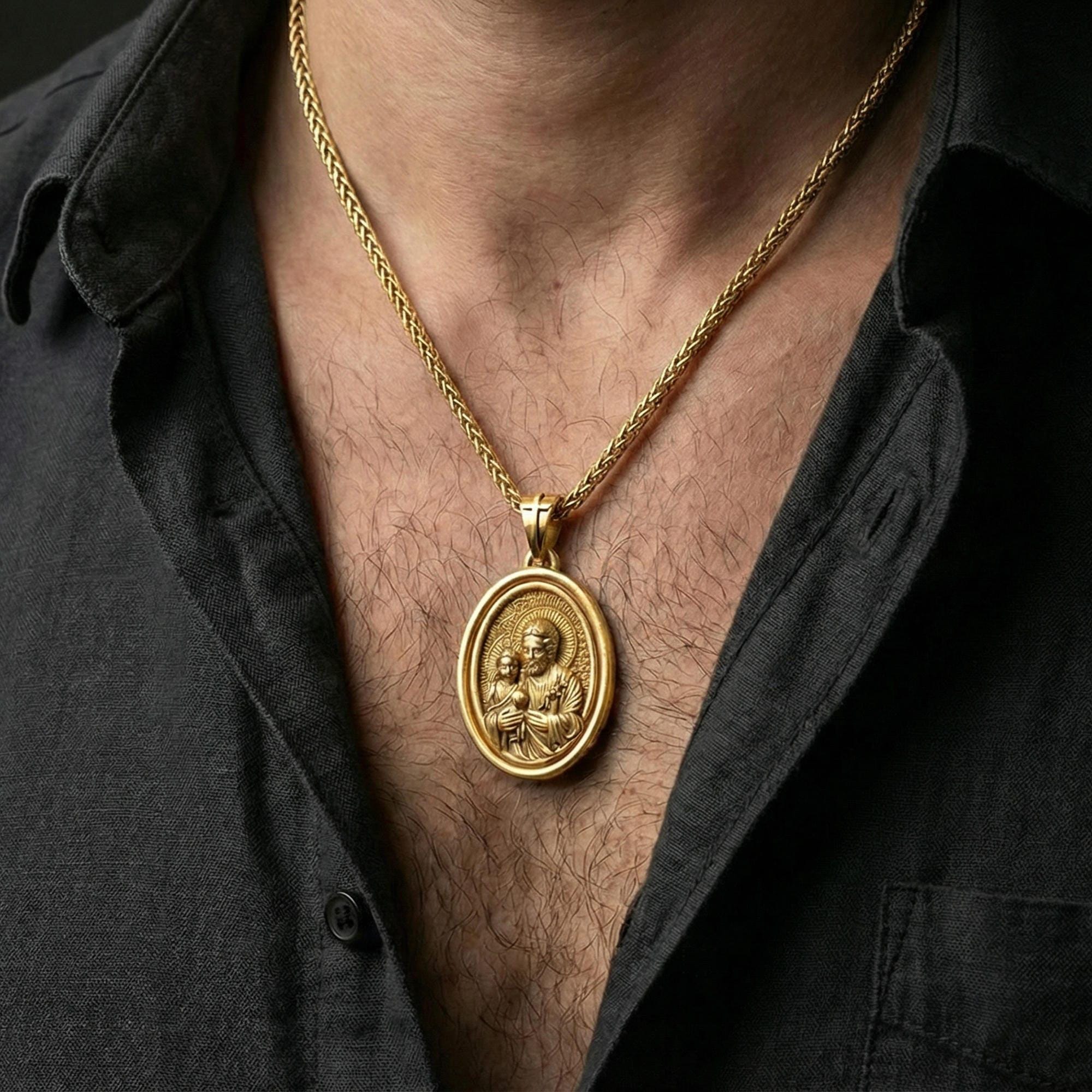 Gold plated Saint Joseph necklace pendant worn on neck, close-up lifestyle shot, luxury lighting with refined metallic highlights