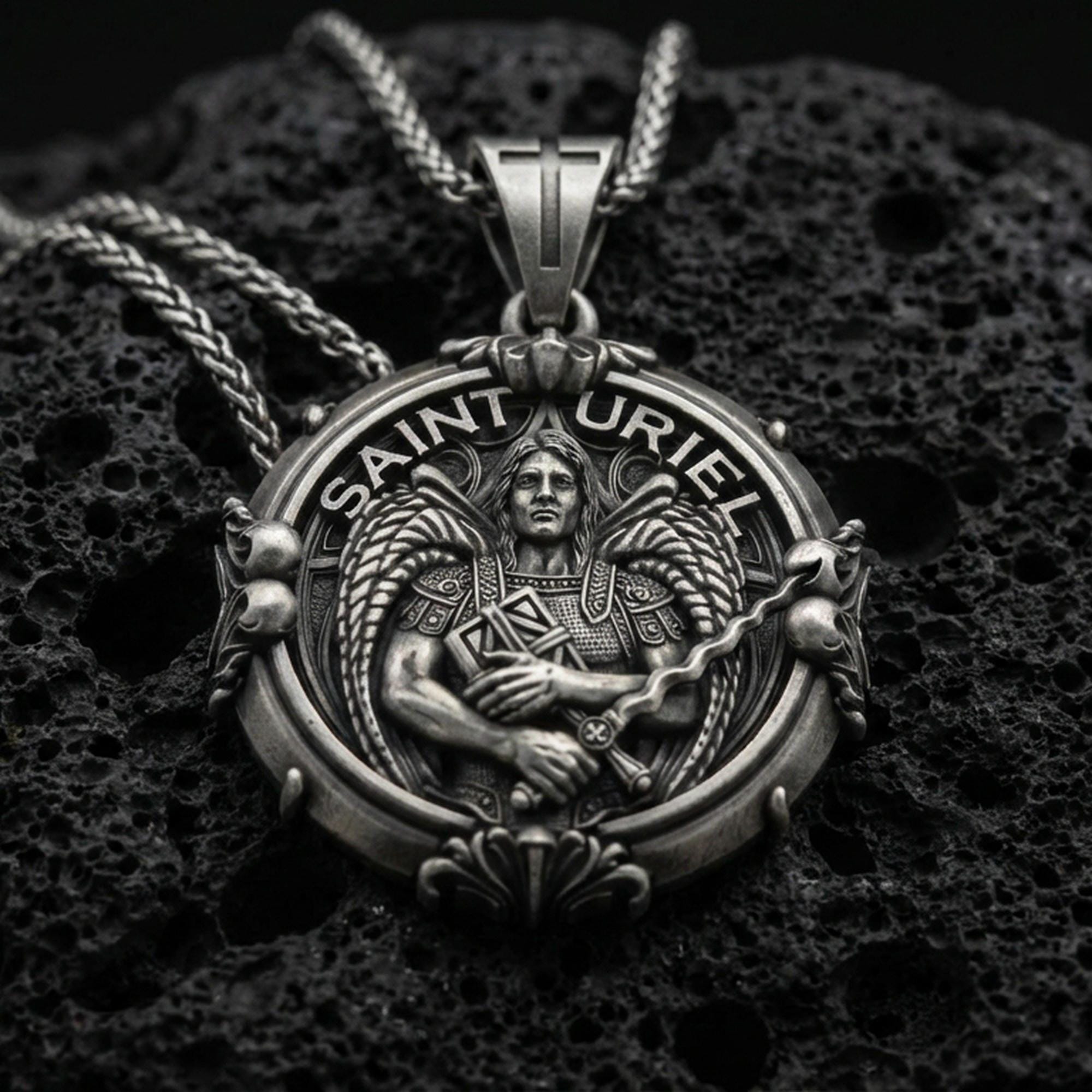 Oxidized Saint Uriel pendant on textured volcanic rock, macro close-up, angel warrior medallion detail, premium studio lighting