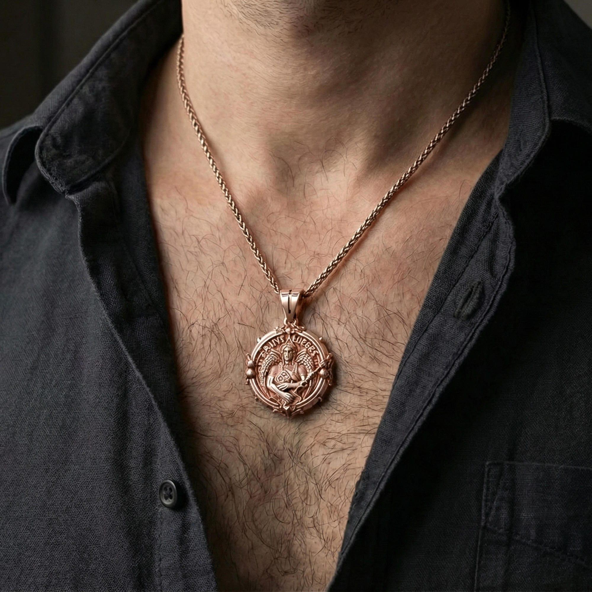 Rose gold plated Saint Uriel pendant necklace worn on neck, lifestyle composition with dark clothing, crisp medallion silhouette