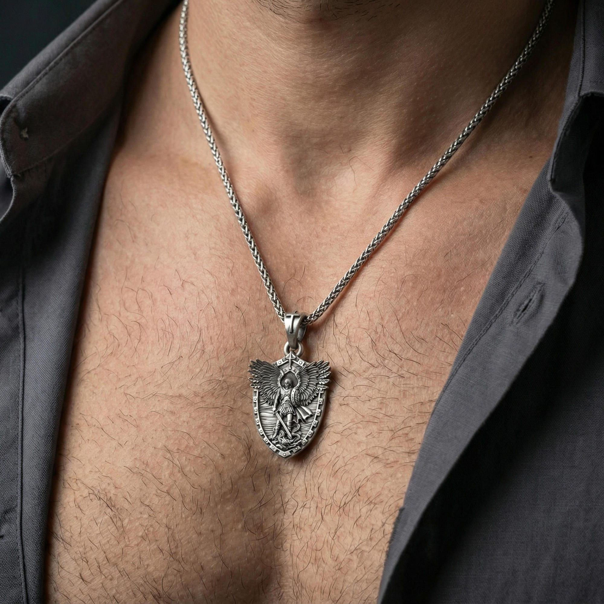 Oxidized Archangel Michael shield pendant necklace worn on neck, lifestyle close-up on dark outfit, shield medallion centered