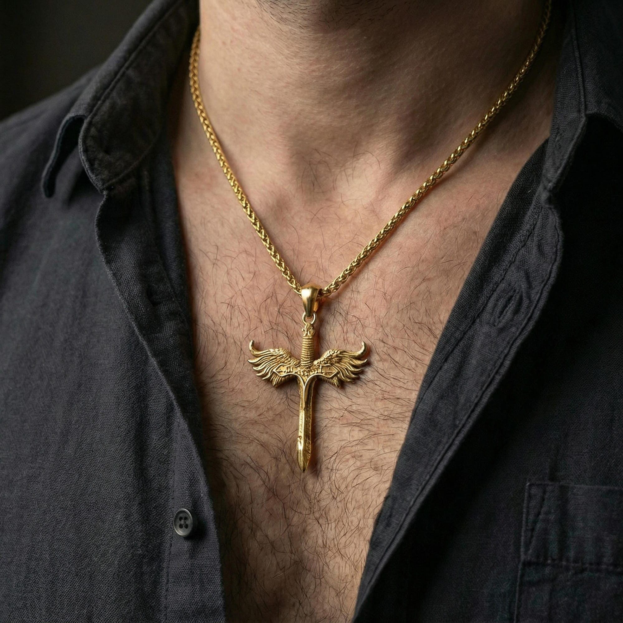 Gold plated Archangel Michael sword necklace pendant worn on neck, close-up lifestyle shot, luxury lighting with refined metallic highlights