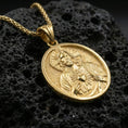 Load image into Gallery viewer, Gold plated Sacred Heart of Jesus medallion pendant displayed on porous volcanic rock surface, close-up studio composition, detailed religious relief
