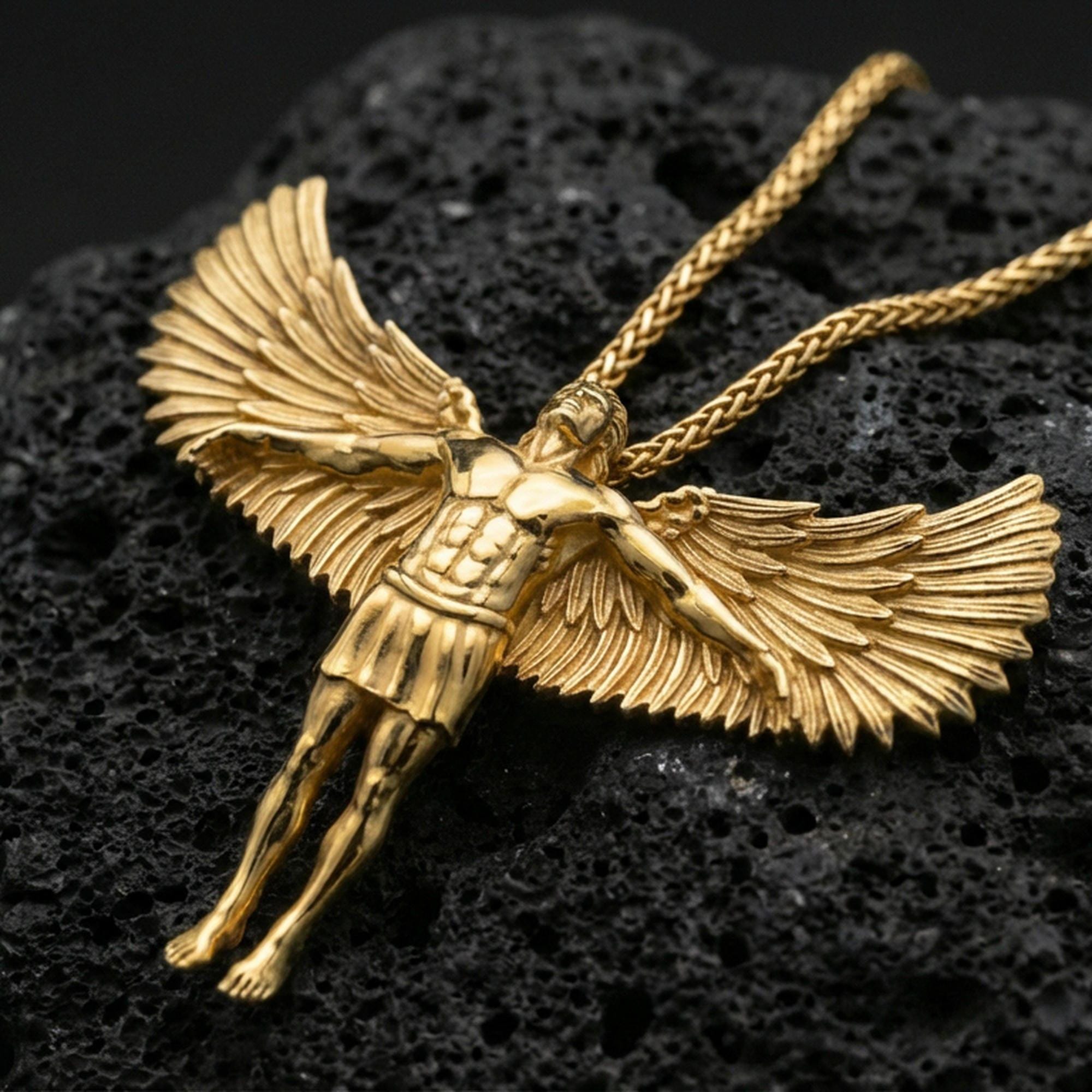 Gold plated Archangel Michael pendant displayed on porous volcanic rock surface, close-up studio composition, detailed angel wings and body relief
