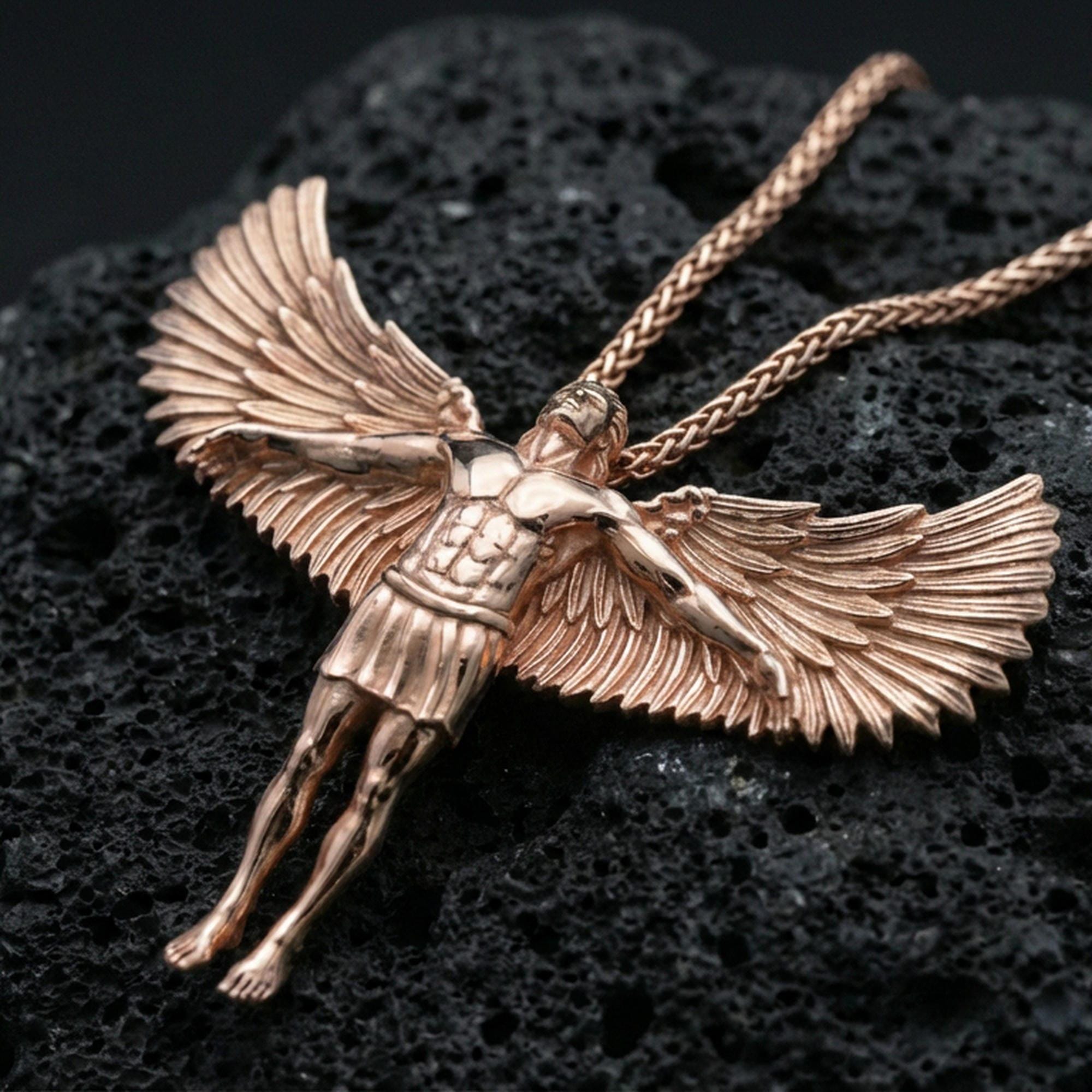 Rose gold plated Archangel Michael protection pendant on volcanic rock, premium macro product photo, sharp feather texture and figure silhouette