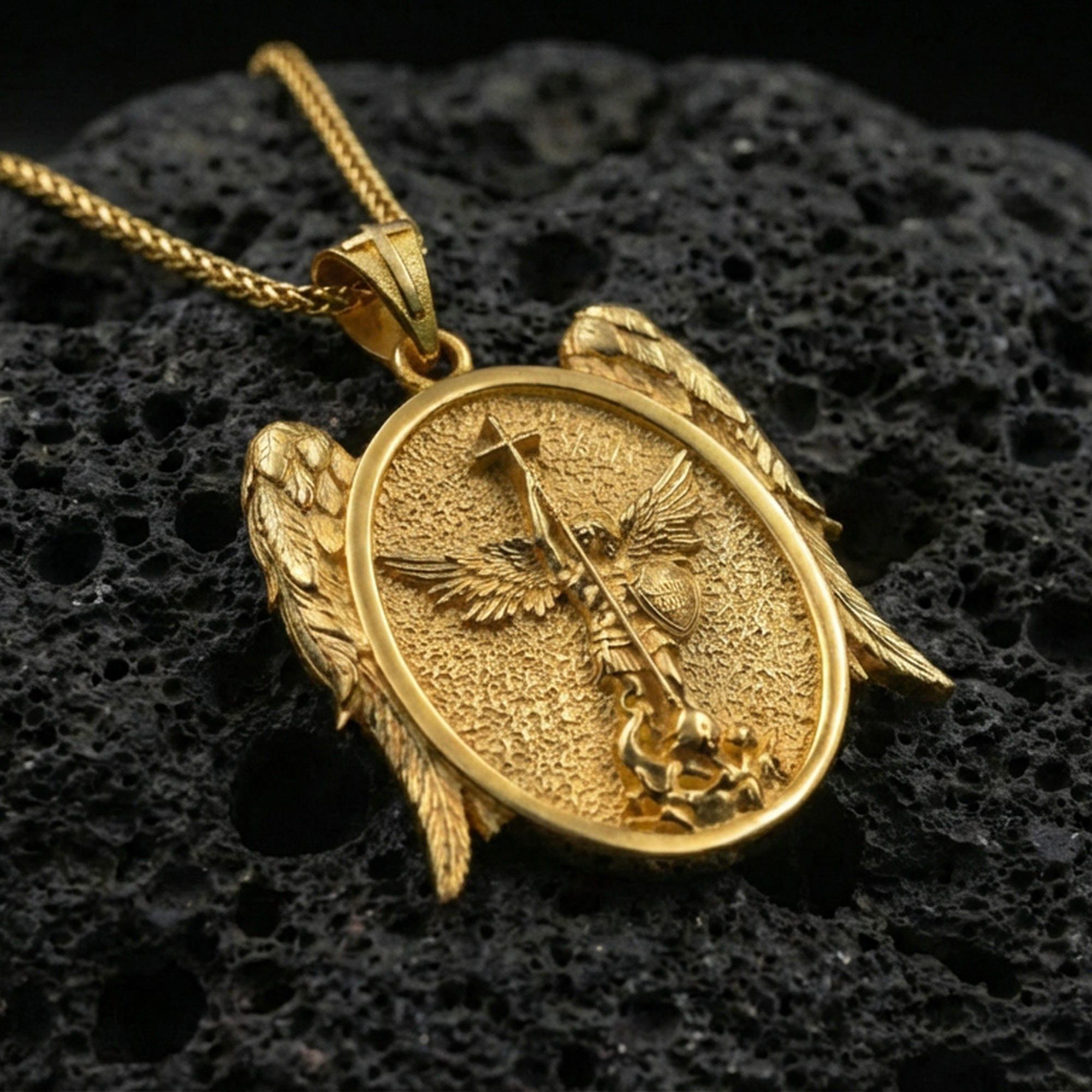 Gold plated Saint Michael archangel pendant displayed on porous volcanic rock surface, close-up studio composition, detailed wings and oval frame