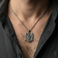 Load image into Gallery viewer, Oxidized Saint Michael archangel pendant necklace worn on neck, lifestyle close-up on dark outfit, oval medallion centered
