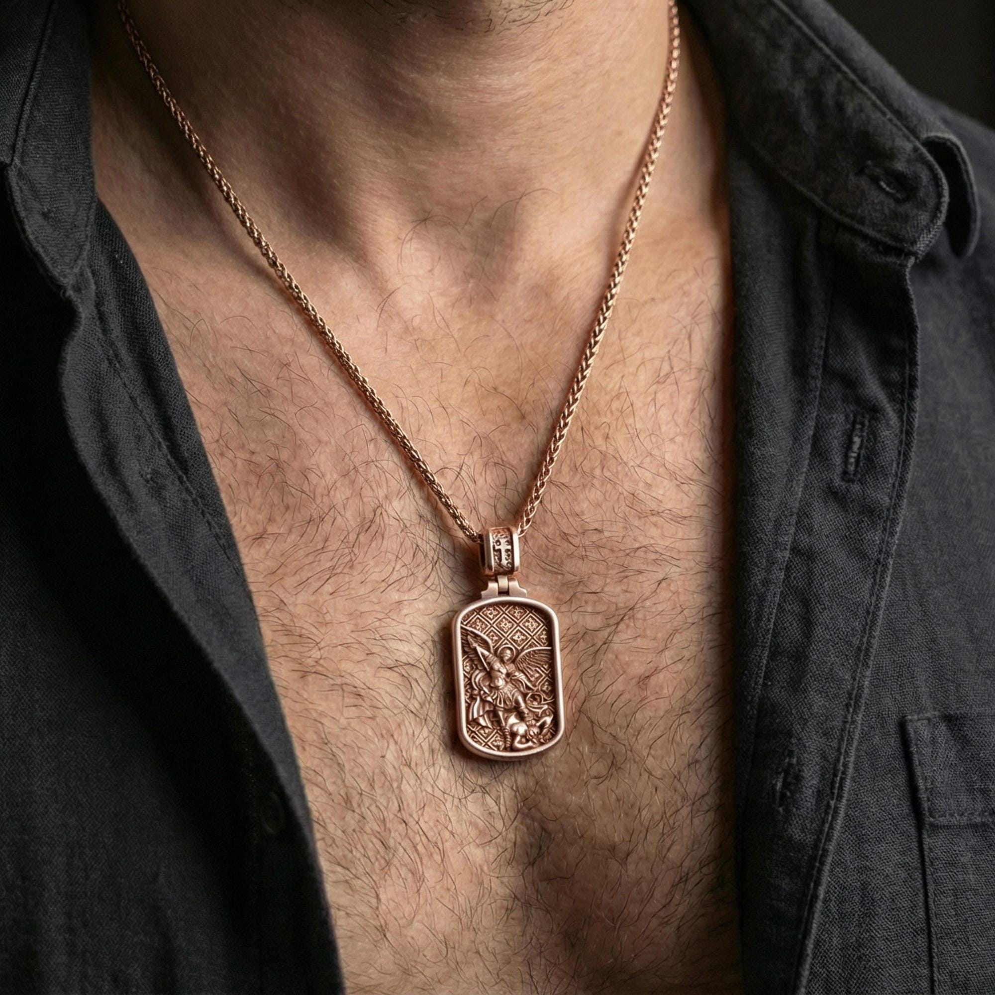 Rose gold plated Archangel Michael dogtag pendant necklace worn on neck, lifestyle composition with dark clothing, crisp dog tag silhouette