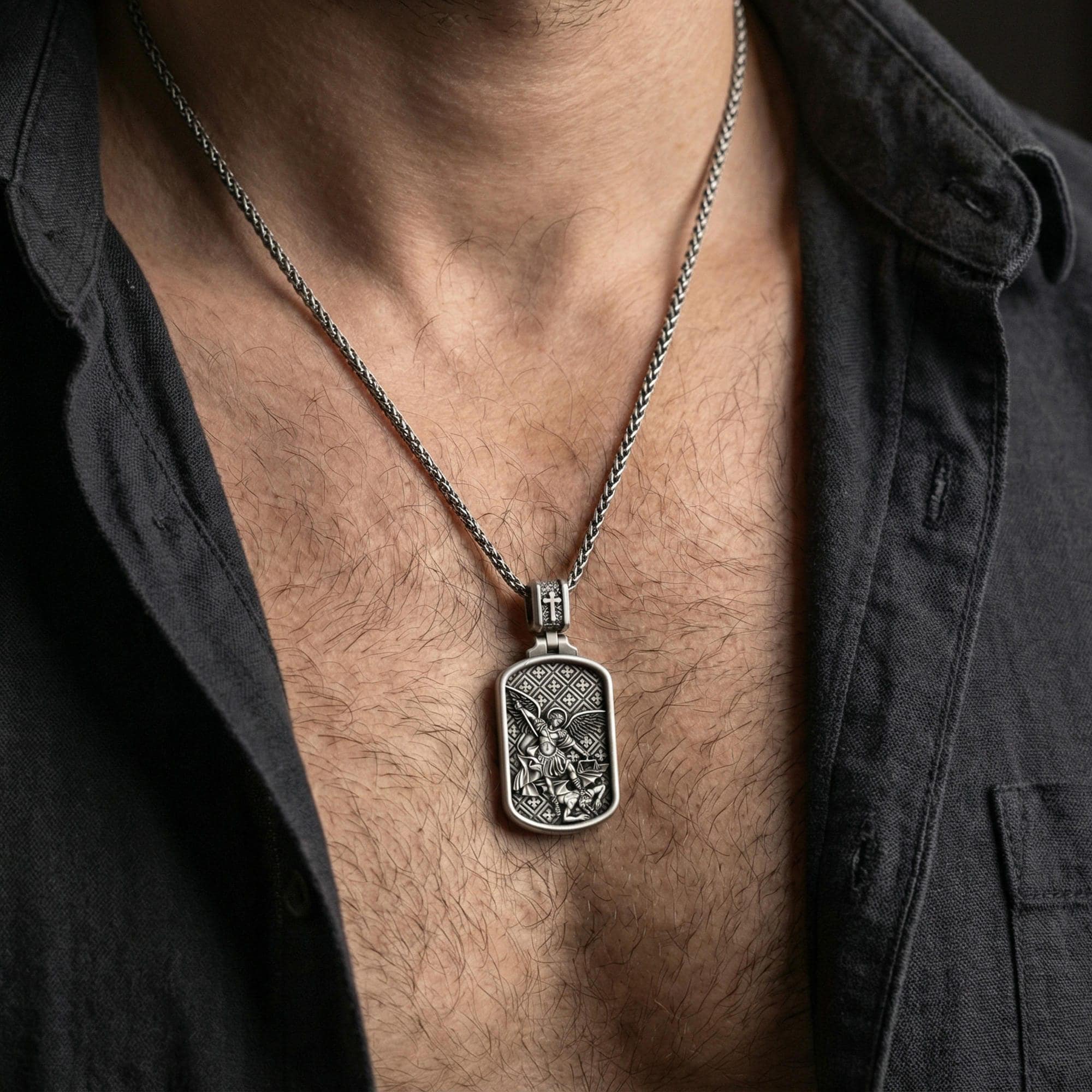 Oxidized Archangel Michael dog tag pendant necklace worn on neck, lifestyle close-up on dark outfit, rectangular pendant centered