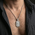 Load image into Gallery viewer, Polished silver Archangel Michael dogtag pendant on chain worn on neck, natural lifestyle framing, angel relief clearly visible
