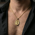 Load image into Gallery viewer, Gold plated Saint Andrew oval pendant necklace on neck, warm highlights, premium lifestyle composition, religious jewelry focus
