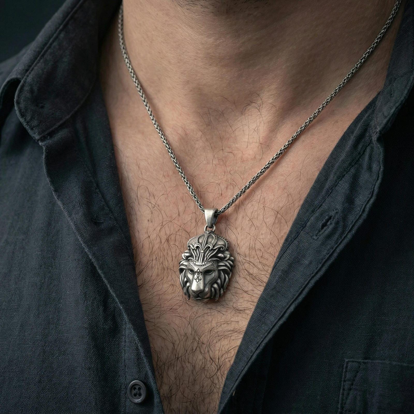 Oxidized lion head pendant necklace worn on neck, dark outfit lifestyle close-up, bold regal animal jewelry focus