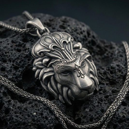 Oxidized lion head pendant necklace on volcanic rock, regal crown-inspired mane details, macro close-up, premium studio lighting