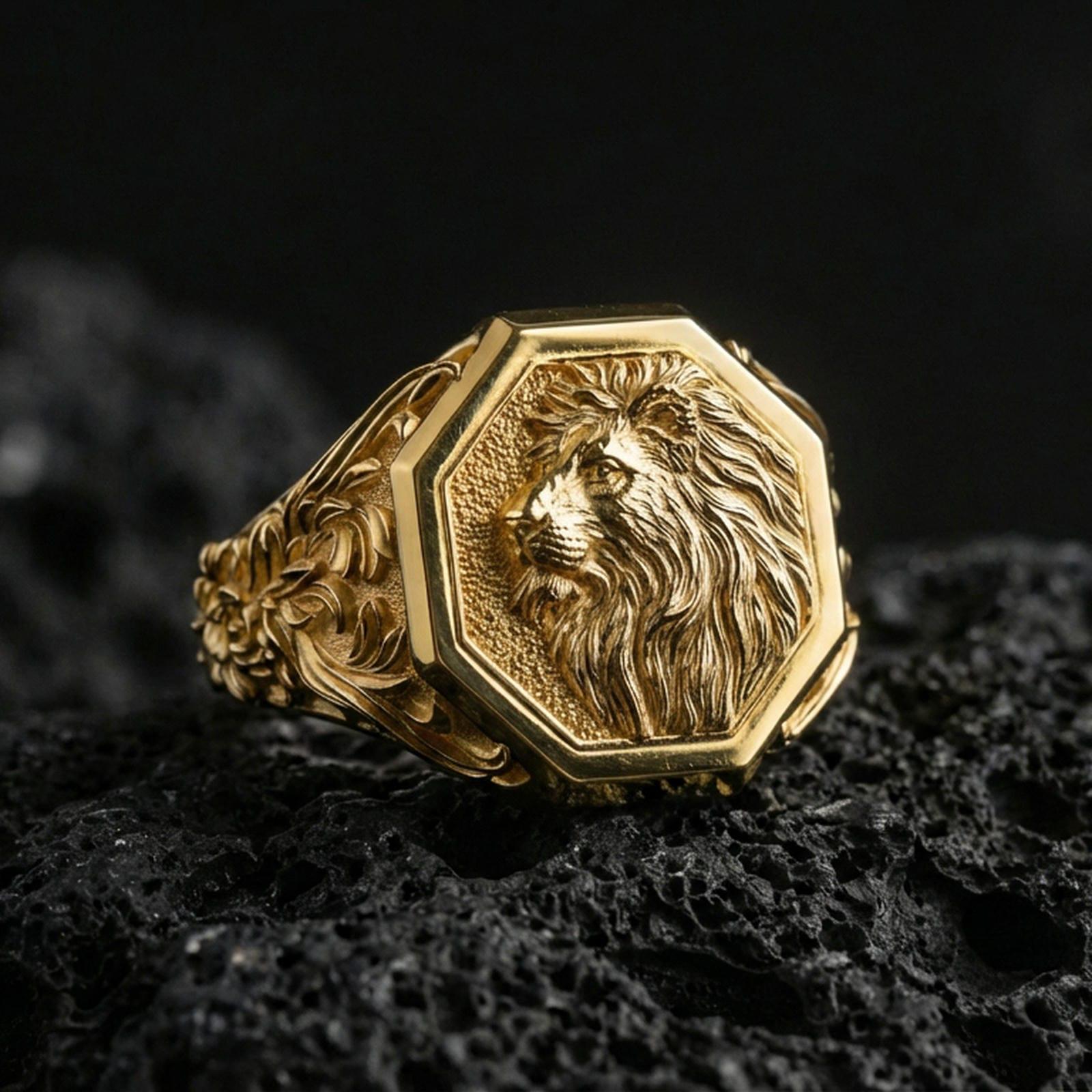 Gold plated lion signet ring on volcanic rock, octagon crest design with sculpted lion profile and dark recessed texture for strong contrast, macro lighting