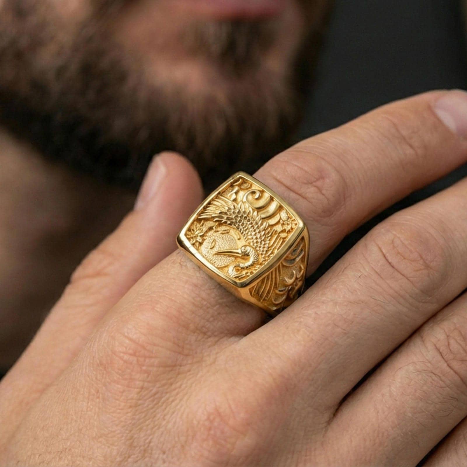 925 sterling silver crane signet ring worn on a finger, gold plated finish with premium shine and detailed crane-and-floral relief