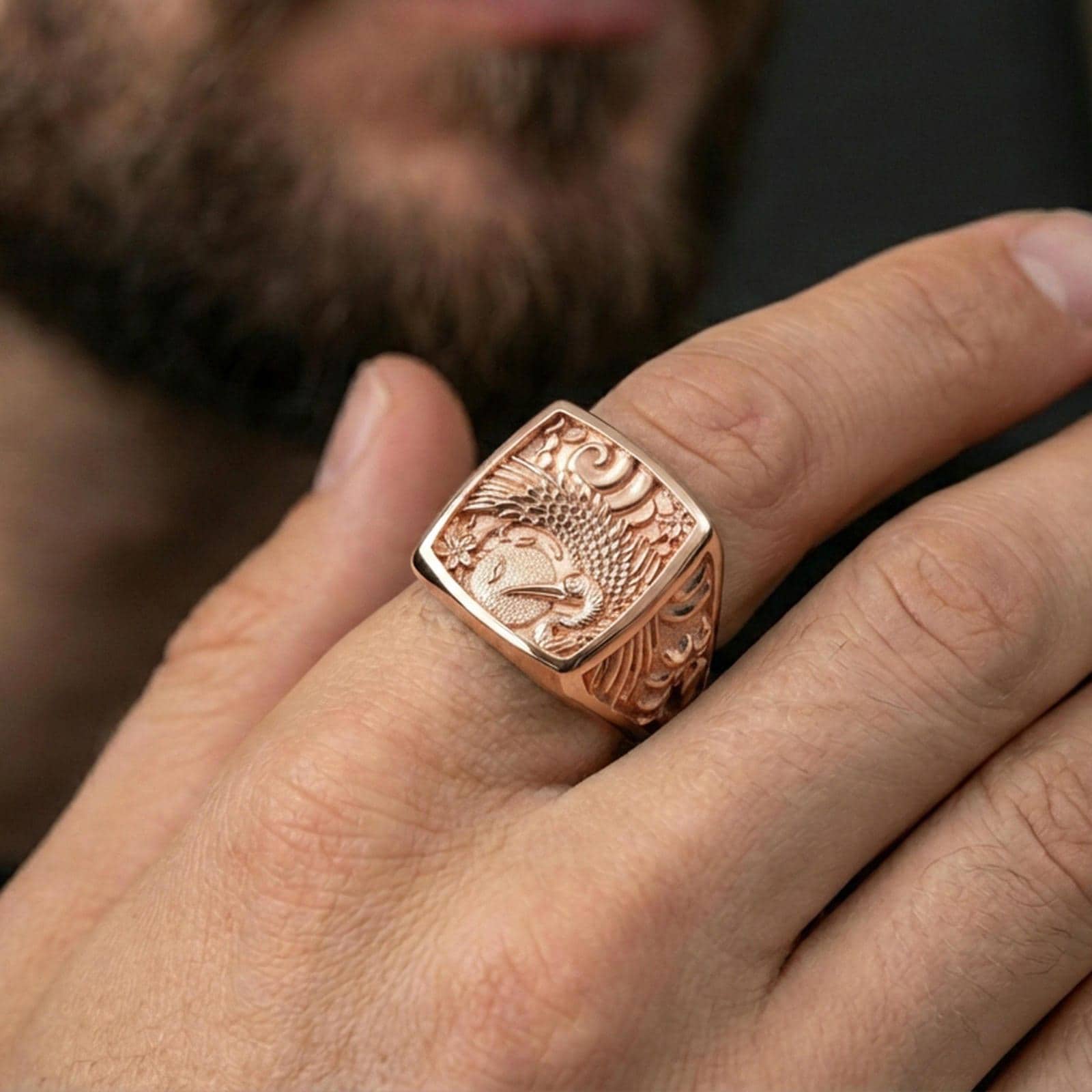 925 sterling silver crane signet ring worn on a finger, rose gold plated finish with smooth luster and bold engraved crane design