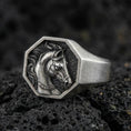 Load image into Gallery viewer, Oxidized sterling silver horse signet ring on textured volcanic rock, octagon face with detailed stallion portrait in macro studio shot
