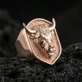 Load image into Gallery viewer, Rose gold plated bull signet ring on volcanic rock, sharp macro product photo showcasing the shield top and bold bull relief
